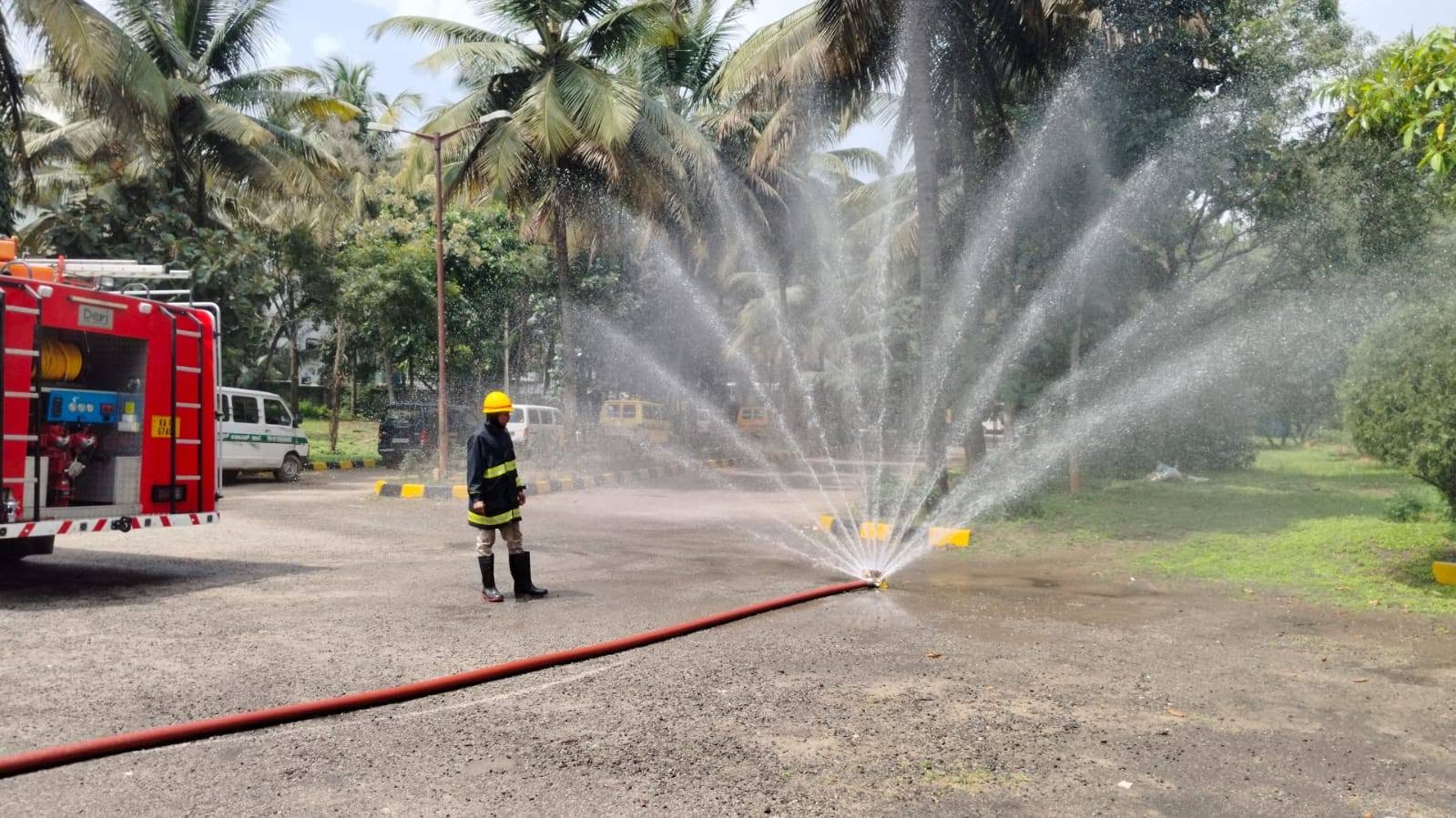 Firefighter demonstrating a water spray to children on a school trip