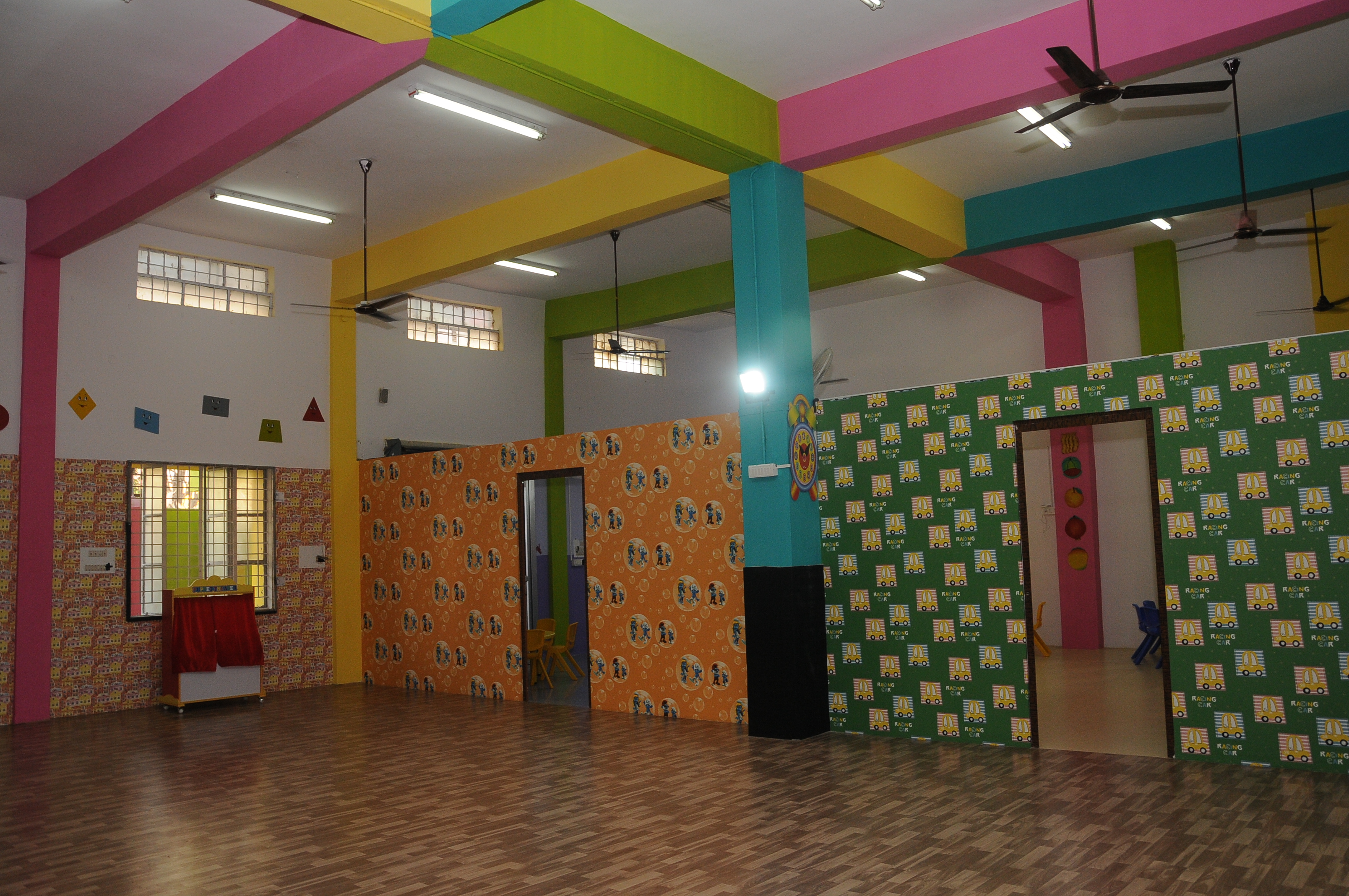 Colourful indoor assembly area at Kids Mansion